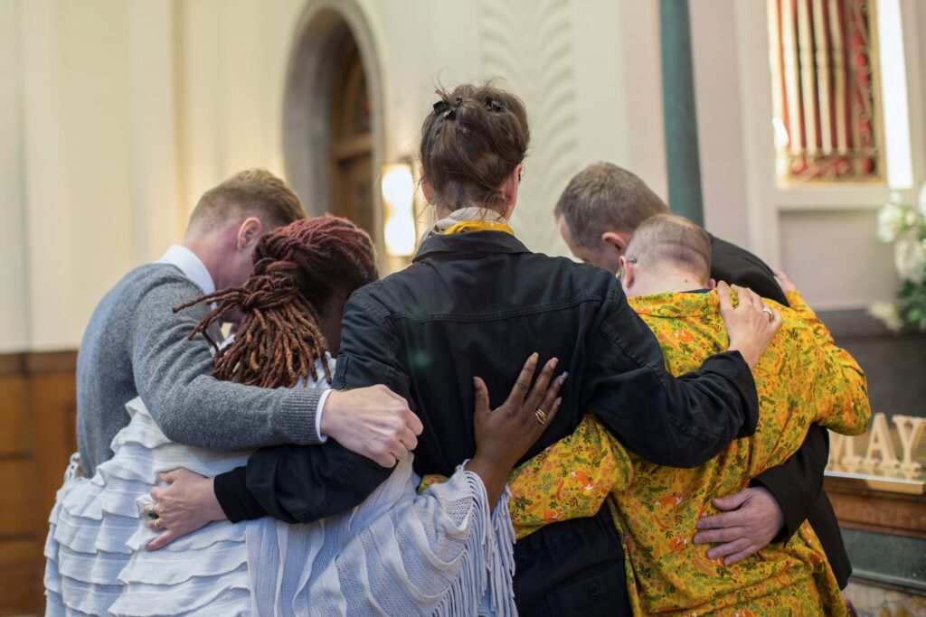 grief fellowship, people arm in arm - Michael J. Penney Show