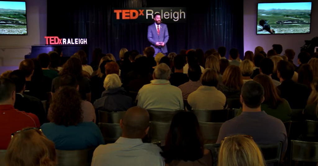 TEDxRaleigh Audience Michael J. Penney on stage