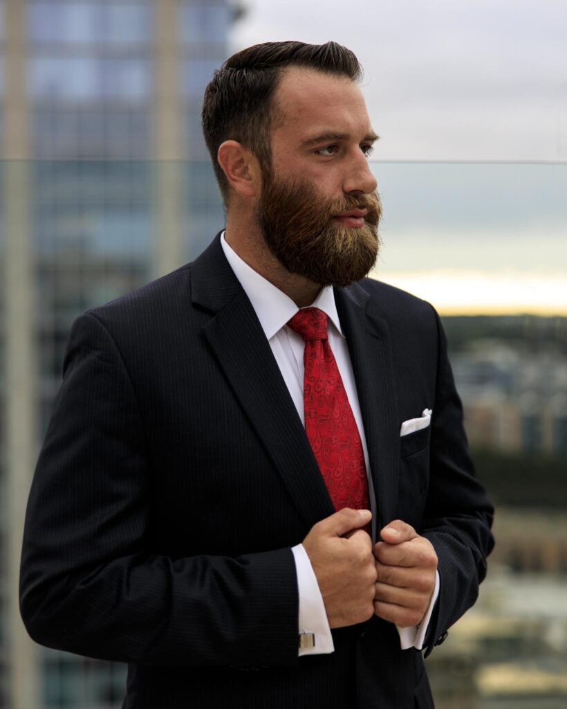 Michael J. Penney with hands on his lapels gazing at the city, color photo, Michael J. Penney, MJPenney