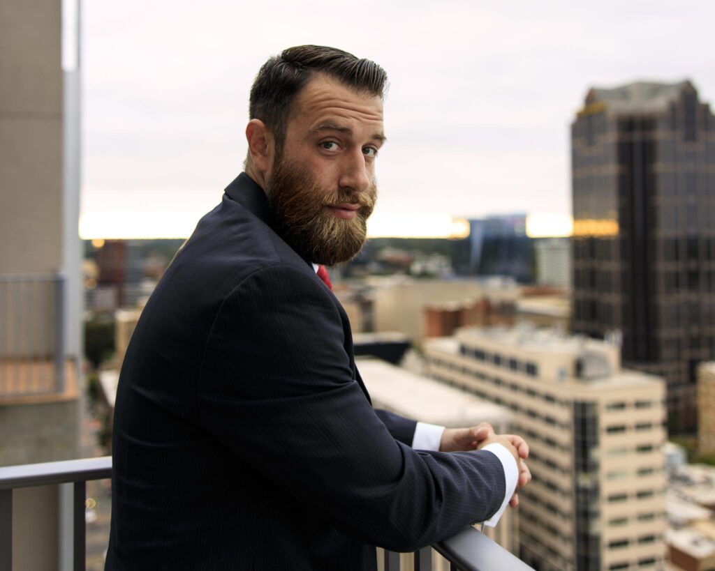 Michael J. Penney turning towards the camera over the city, color photo, Michael J. Penney, MJPenney