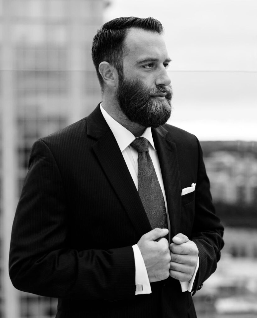 Michael J. Penney with hands on his lapels gazing at the city, black and white photo, Michael J. Penney, MJPenney